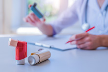 Doctor Writes Medical Prescription For Asthma Inhaler To Asthmatic Patient During Medical Consultation And Examination In Hospital. Healthcare