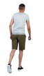 © ghoststone - Back view of going handsome man in shorts.