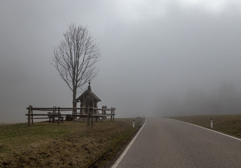 the old chapel in a fog alps, austria