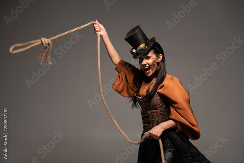 Cuadros en Lienzo attractive steampunk girl in top hat holding lasso and screaming isolated on gre
