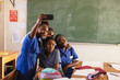 © Wavebreak Media - Schoolchildren taking selfies during a break at a township school
