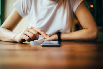 Wall Mural - Unrecognizable young woman using smart phone