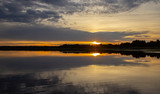 Fototapeta Sypialnia - Evening at the lake. Water surface. Beautiful sunset.
