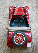 The Above View Of Vintage Car With Spare Wheel. The Red Classic Car With Classical Wheel On Rear.
