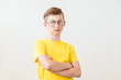 © irena_geo - Serious teen boy with big glasses on white background.