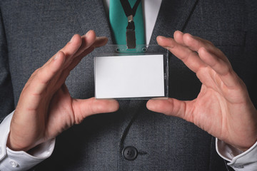 Blank name badge with a copy space in a businessman hands.