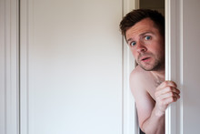 Young Caucasian Naked Man Hiding In Wardrobe
