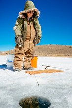 A Man Is Fishing For Trout On Iced Over Panguitch Lake, Dixie National Forest