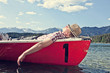 © Westend61 - Germany, Bavaria, Mid adult man sleeping in rowing boat