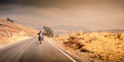 Wall Mural - A motorbiker drives through the Peruvian Highlands, Peru