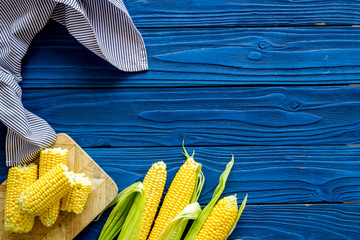 Wall Mural - Cob corns on blue wooden background top view mockup