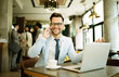 © bugarskipavle3 - Young businessman uses a laptop in a cafe and talking mobile