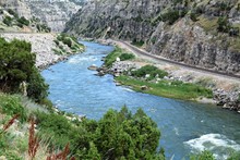 The Beauteous Wind River, Wyoming, Travels Through Steep Canyon Walls By A Winding Railroad Track