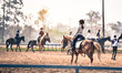 young girl is training to ride a horse horse is in the practice field
