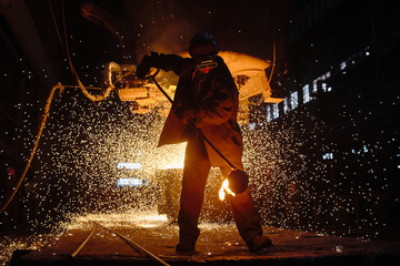 Wall Mural - Steelmaker at ingot casting. Electric arc furnace shop EAF. Metallurgy.