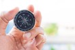 © TECHNOLOGY FACTORY - man holding compass on blurred background. for activity lifestyle