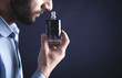 © andranik123 - Caucasian young man smelling perfume.