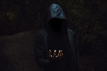 Man In A Hood With Light On His Hand