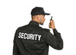 © New Africa - Male security guard in uniform using portable radio transmitter on white background
