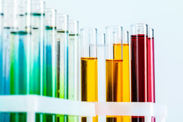 Different laboratory glassware with colored liquids close up