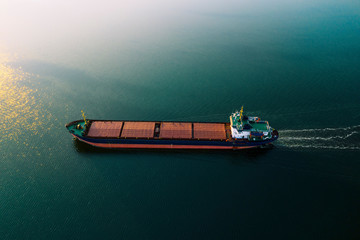 Shipping cargo to harbor by ship. Water transport International. Aerial view