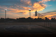 © huawoon - silhouette of outdoor basketball court with dramatic sky in the sunrise morning