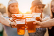 © minastefanovic - Female friends cheering with beer at music festival