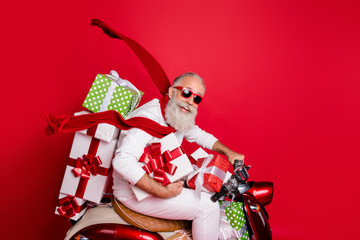 Profile side view of nice attractive funny funky cheerful gray-haired man riding motor delivering pile stack new desirable purchase air wind blows isolated over bright vivid shine red background