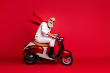 Crazy Aged Santa Man Coming Newyear 2020 Party By Vintage Moped Wear Jumper And Trousers Isolated Red Background