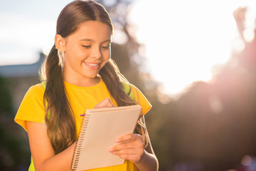 Wall Mural - Close-up portrait of her she nice winsome attractive charming cute lovely intelligent brainy cheerful wavy-haired girl writing example Maths in the street park town outside