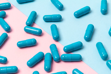 Wall Mural - Blue pills on pink background. Template for feminine beauty blog social media