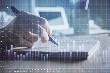 Financial charts displayed on woman's hand taking notes background. Concept of research. Double exposure