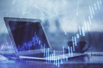 Stock market graph and table with computer background. Double exposure. Concept of financial analysis.