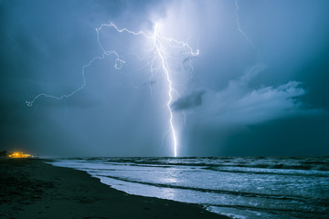 Bright lightning bolt strikes in the North Sea during a summer thunderstorm