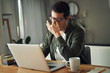 © StratfordProductions - Man massaging nose feeling fatigue using laptop at home
