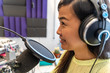 asian girl host in radio station hosting show for radio live in Studio
