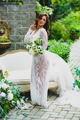 Young sexy bride posing with bridal bouquet