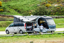 Motorhome RV And Campervan Are Parked On A Beach.
