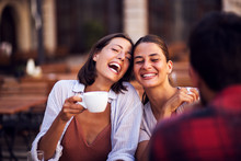 Smiling Friends Drinking Coffee And Laughing