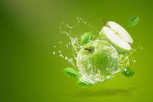 Water Splashing On Fresh Green Apple On Green Background