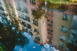 © Irina84 - Reflection in the puddle of water. Apartment house with balconies. Blue sky with clouds in the puddle.
