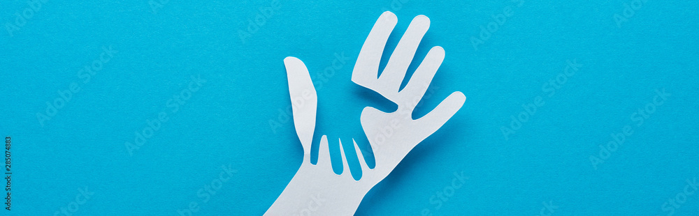 top view of paper cut parent and child hands on blue background, panoramic shot - obrazy, fototapety, plakaty 