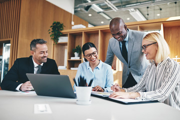 Diverse group of businesspeople laughing together during an offi