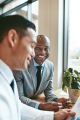 Smiling African American businessman working with a colleague