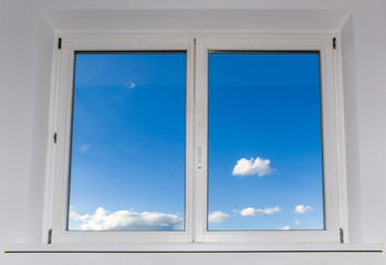 view of closed white window overlooking blue sky with clouds, view from home