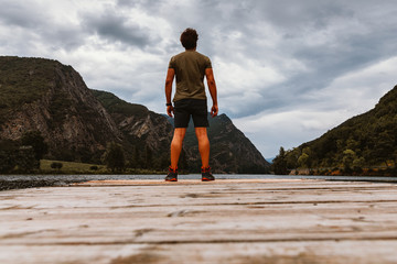 Rear view of a man on a wooden walkway