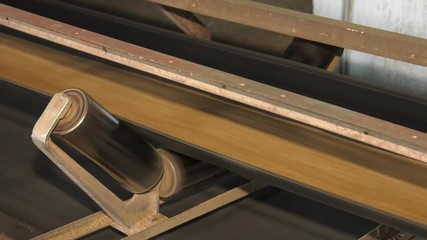Wall Mural - Plant for storage and processing of grain, grain moves along a conveyor belt, conveyor belt with cereal