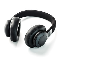 Wireless black headphones on white, isolate. On-ear headphones for playing games and listening to music tracks. Close-up