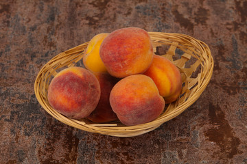 Peach heap in the wooden basket