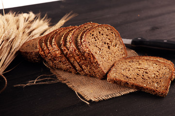 freshly baked bread on wooden board. cutted organic bread